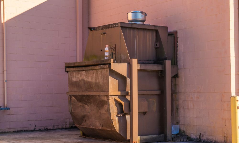trash compactor outside of a grocery store