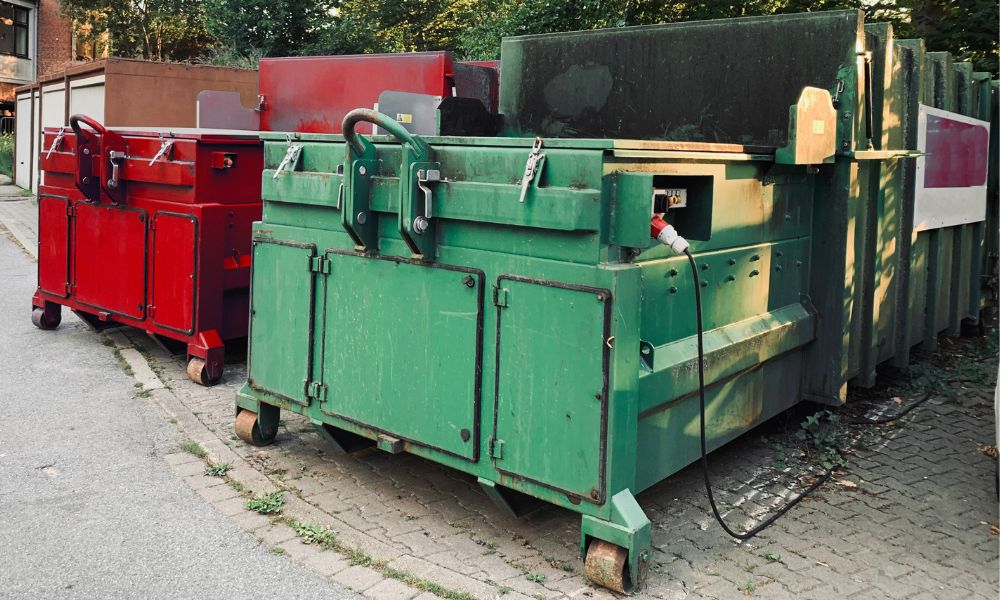 waste compactors outside of a residential building